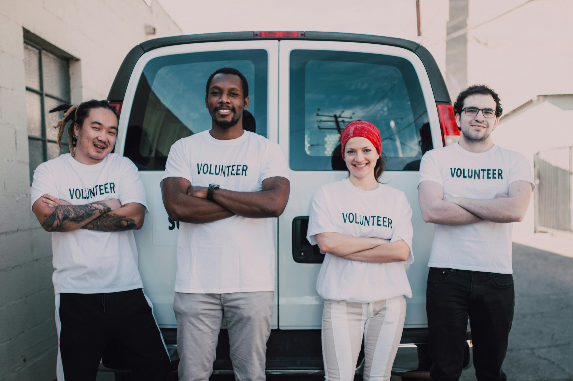 4 people with shirts that say "Volunteer" on them