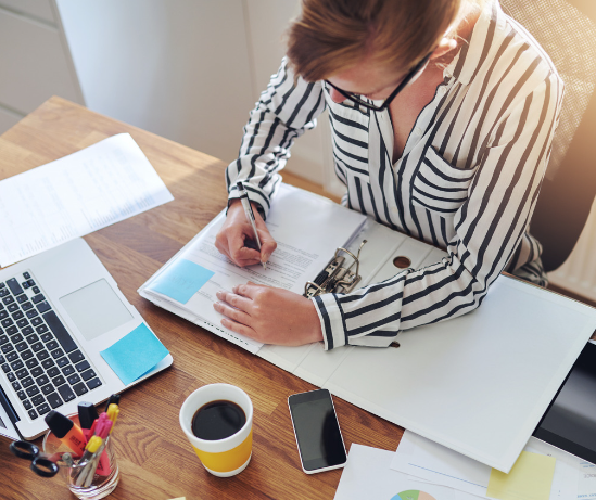 Woman writing at her desk