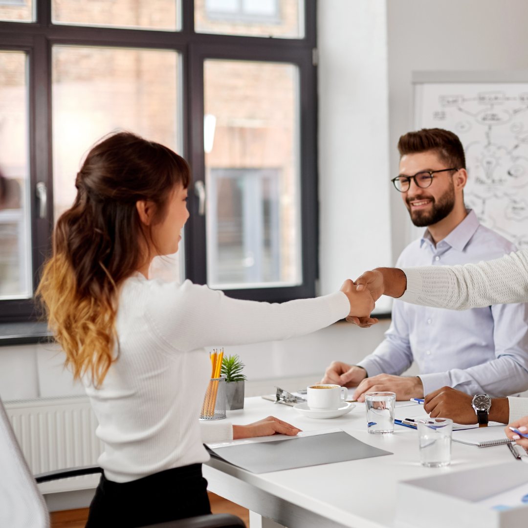 Woman shaking hands at an interview