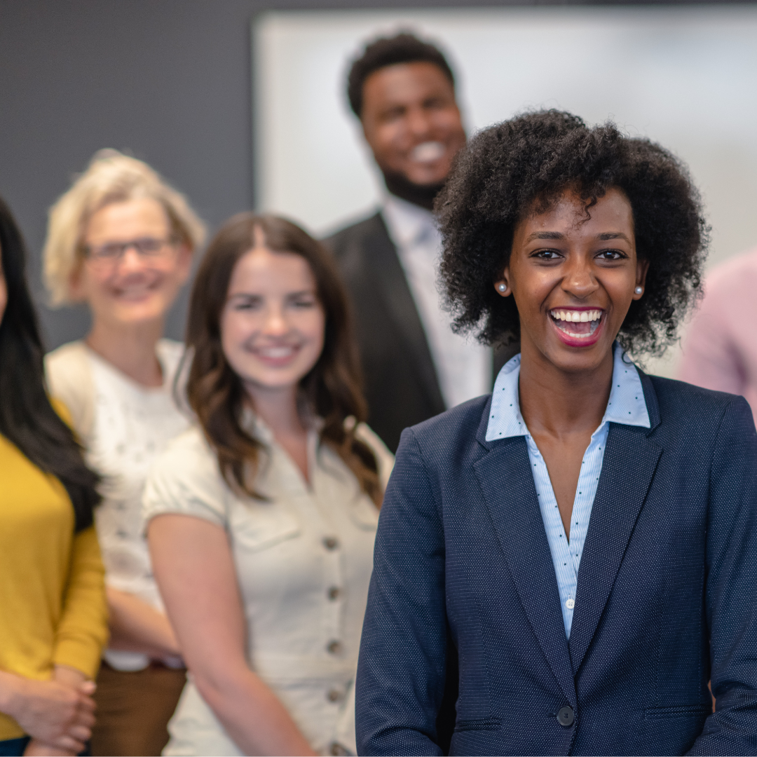 Women stands in front of her team as a leader